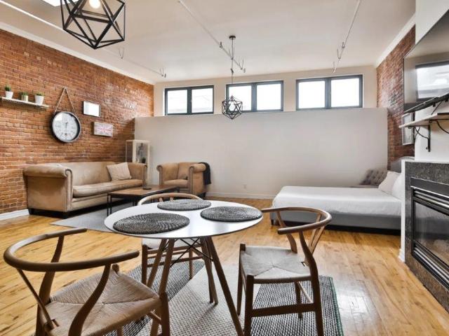 Montreal Furnished Loft Rental in Ville Marie Spacious Studio with 1 Bath plus Fireplace and Exposed Brick