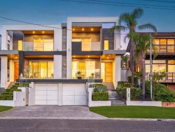 MODERN FOUR BEDROOM HOME WITH THREE CAR BASEMENT