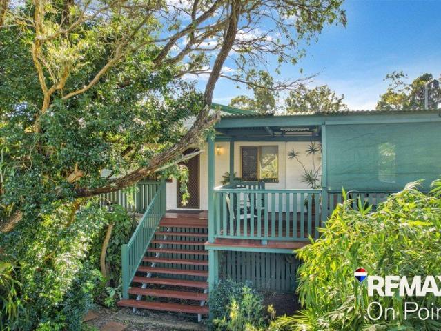 Modern Queenslander Wrap Around Verandahs, Polished Timber Floors, Shed, Solar & Air Con in a Prime Island Location