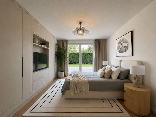Moderne Neubauwohnung mit Terrasse und grünem Gartenblick