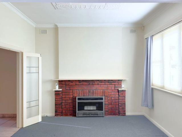 Neat Three Bedroom Home with Secure Parking & Low Maintenance Yard