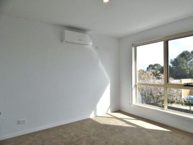 Near New & Bursting with Natural Light!