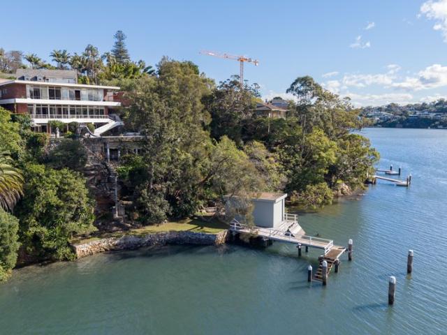 North east facing waterfront designed by Nino Sydney with Harbour bridge view, jetty, mooring pen & boatshed