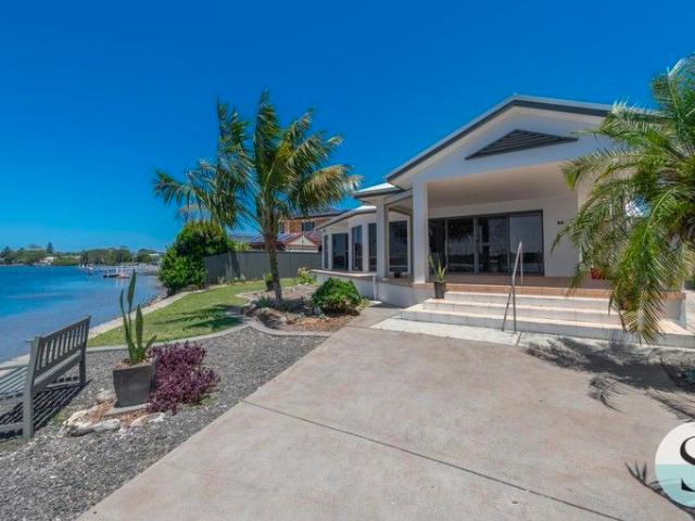 North Facing, Absolute Waterfront, Spread Out Over One Easy Level of Architecturally Innovative Living with Garaging Galore!