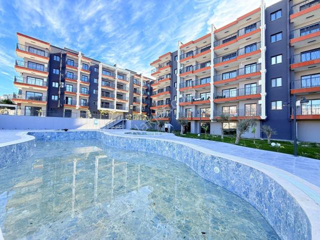 Şok Fiyat ! Kuşadasında Satılık Merkezı Konum 7/24 Güvenlik havuz bahçe kombi lüx fırsat Daireler