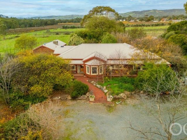 Open the Door to Multi Generational Living on 14 Acres With Mega Shedding and Bore