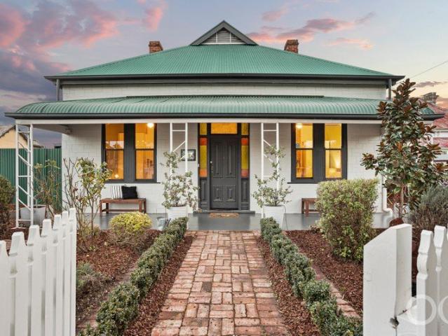Open the Door to a Corner Cottage that Charms from Picket to Pool