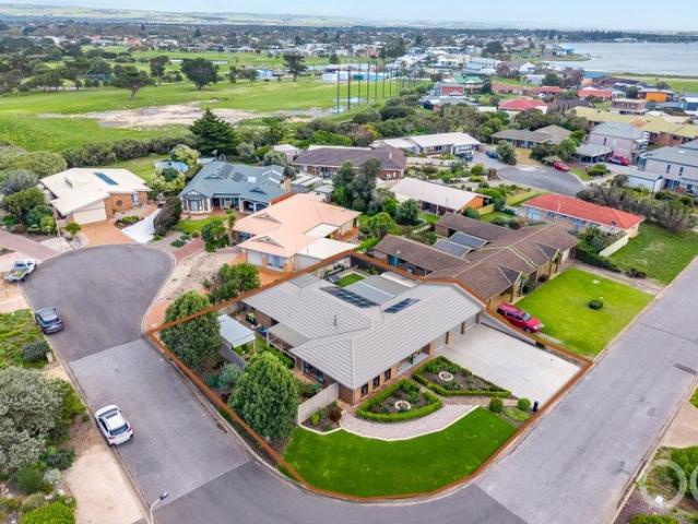 Open the Door to Immaculate Coastal and Golf Course Living, Inside & Out