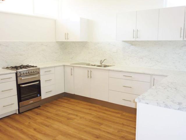Open the Door To Private Courtyard Living in a Premier Burnside Location