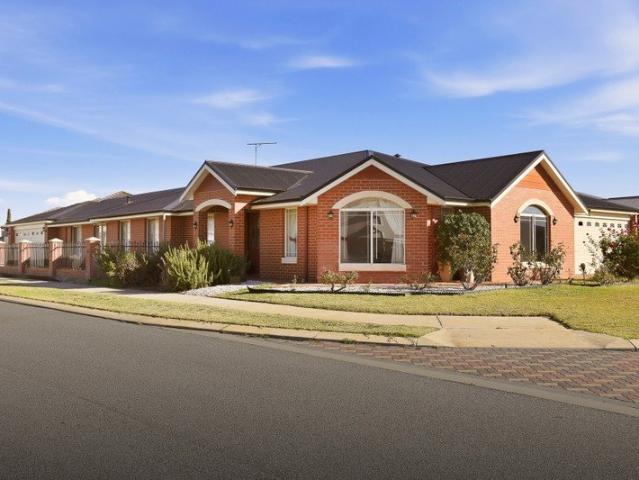 OVERSIZED FAMILY LIVING WITH A SWEEPING CORNER BLOCK AND TWO SEPARATE GARAGES FOR THE VEHICLES