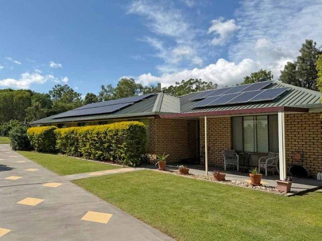 Picture Perfect Brick Home on half acre with Sheds and Beautiful Gardens
