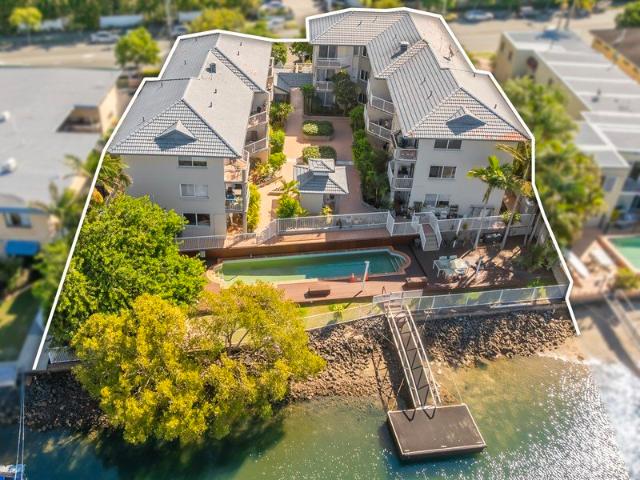 Positioned in a quiet complex right on the water