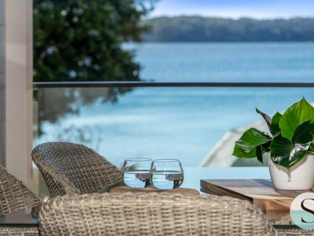 Premium Lakeside Renovation with Stunning Water Views, Underhouse Storage, and a Private Outdoor Spa on a Low Maintenance Elevated Block