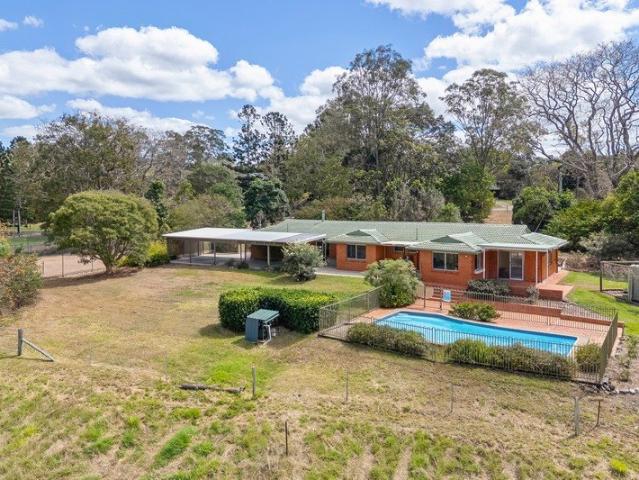 Private acreage sanctuary with outstanding mountain views and creek frontage