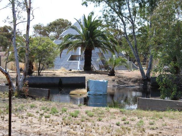 Pyramid house with acreage and dam
