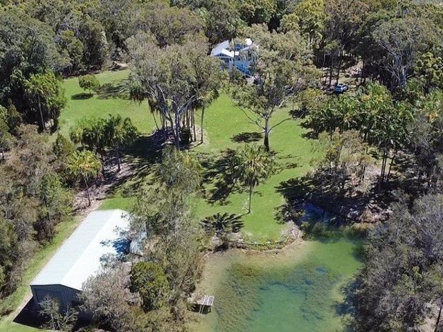 Rare Acreage Coastal Retreat with Private Lakes & Jetty