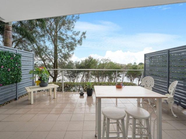 Rare Ground Floor Living with Expansive Lakeside Terrace