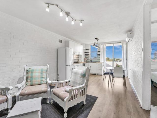 Renovated Fifth Floor Living with Balcony Views and Secure Parking!