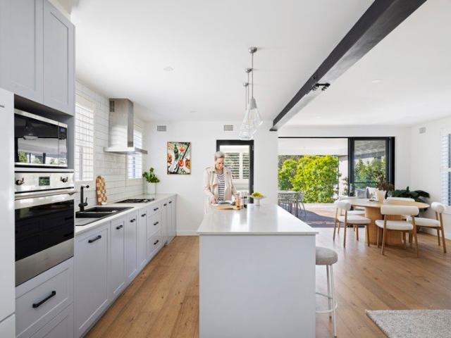 Renovated north facing duplex with a sunlit yard and deck