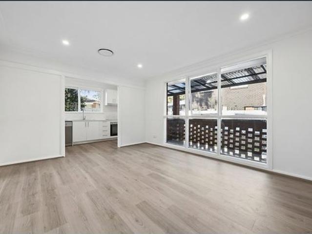 RENOVATED THREE BEDROOM HOME WITH EXPANSIVE SUN FILLED BACKYARD