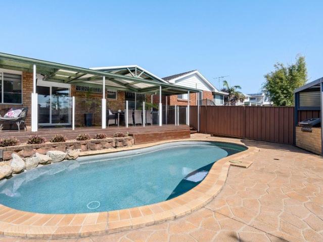Relax poolside in this stylish family home