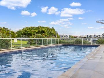 Resort Style Living with Home Office & Serene Water Outlook in Prestigious Cova Estate