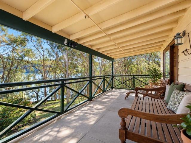 River Retreat with Wide Verandahs and Shared Jetty Access