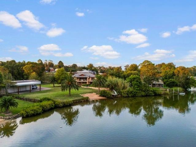 Riverfront Paradise: Poolside Living with Private Water Access