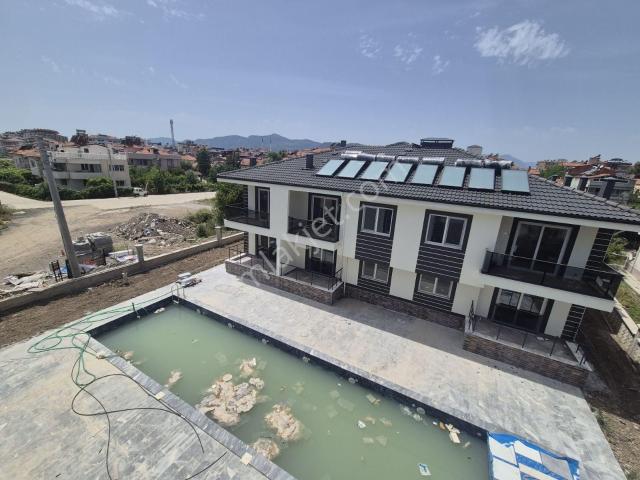 Rotam Emlaktan Ortaca'da Havuzlu Sitede 1+1 Geniş Satılık Daire