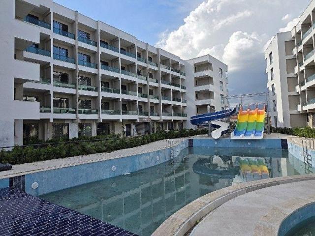 ROYAL'DEN TÖMÜK MAH.YATAY MİMARİ TATİL KÖYÜNDE SATILIK 1+1 DAİRE
