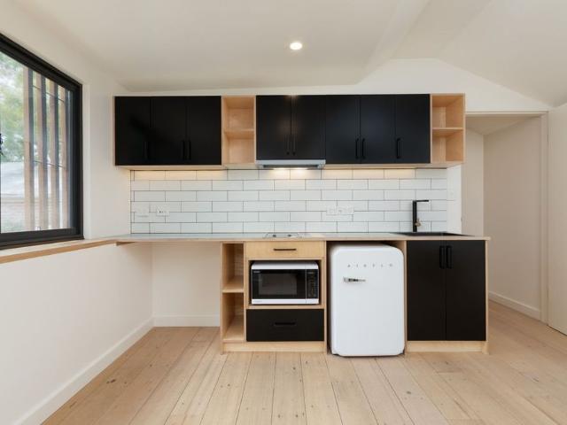 Self contained rear access studio apartment with parking