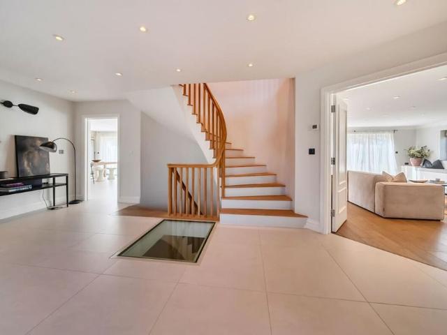 Set on the prestigious Pennypot Lane, Chobham, this substantial detached residence offers approximately 5,723 sq ft of well‑arranged accommodation across three floors