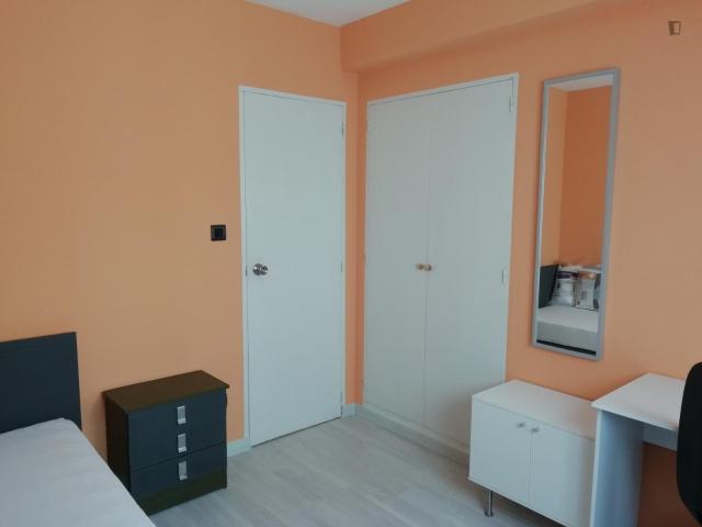 Single bedroom with desk and TV
