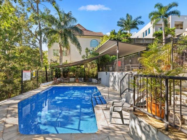 SOLID, WELL BUILT UNIT WITH POOL.