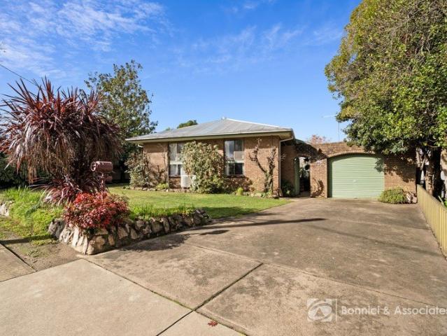 SOLID BRICK COMFORT WITH MODERN UPDATES AND BEAUTIFUL GARDENS