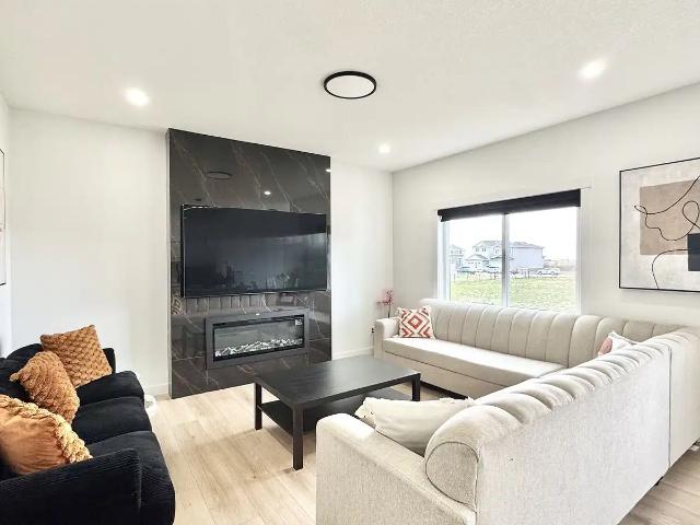 Spacious 3 Bedroom + Den Home with a Double Garage in Strathmore!