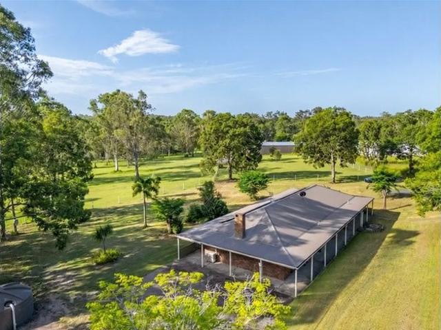 Spacious Acreage Living with Extensive Horse Facilities & Large Sheds
