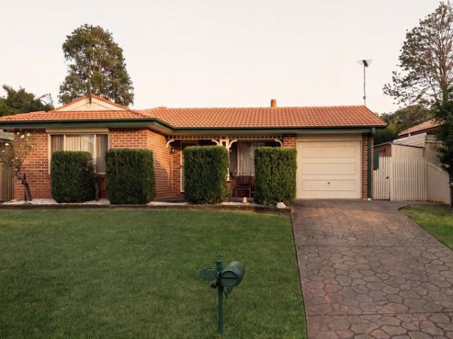 Spacious Brick Home with Inviting Living Areas and Serene Outdoor Space