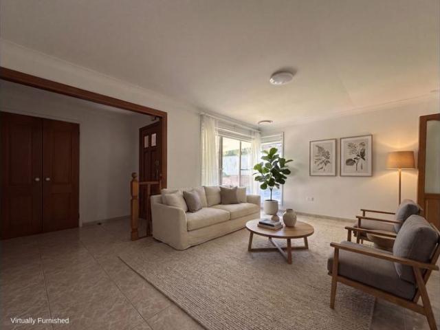 Spacious Brick Home with Sunroom and Versatile Living Areas