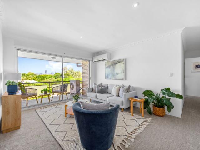 Spacious light filled unit capturing the breeze leafy outlook and city glimpses