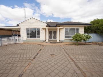 Stone fronted home with a Swimming pool