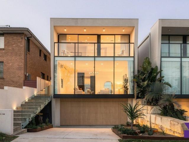 Striking architectural home reveals a flawless, tri level in/outdoor design with basement parking