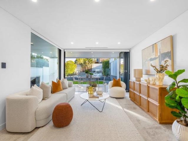 Style, light & quality in stunning dual level residence with water views in Premier Location