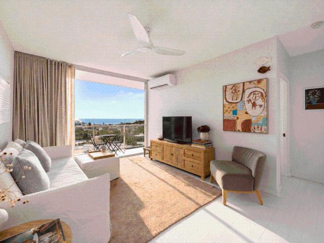 STYLISH FURNISHED OR UNFURNISHED TOP FLOOR APARTMENT WITH WATER VIEWS AND PARKING