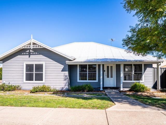 Stylish, Low Maintenance Living in a Walk to Town Position