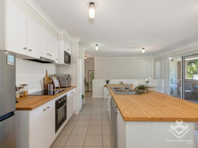 STYLISH, LOW MAINTENANCE LIVING IN A PEACEFUL FOREST SIDE POCKET