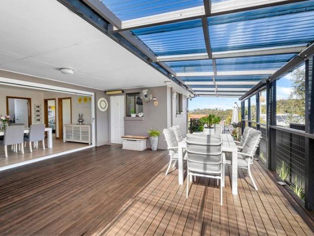 Sunlit Family Living with Gardens and Ocean Blue