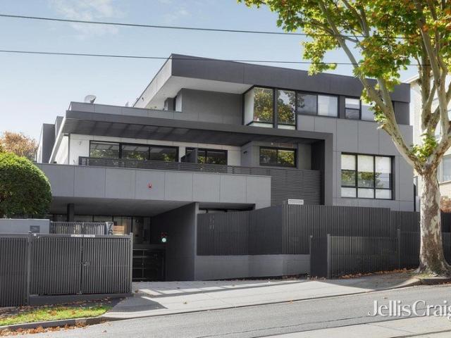 Sunlit Toorak penthouse with house scale living & four car parks