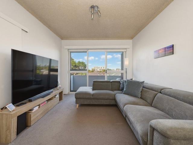 Sunlit Top Floor Living with District Views and Unbeatable Convenience